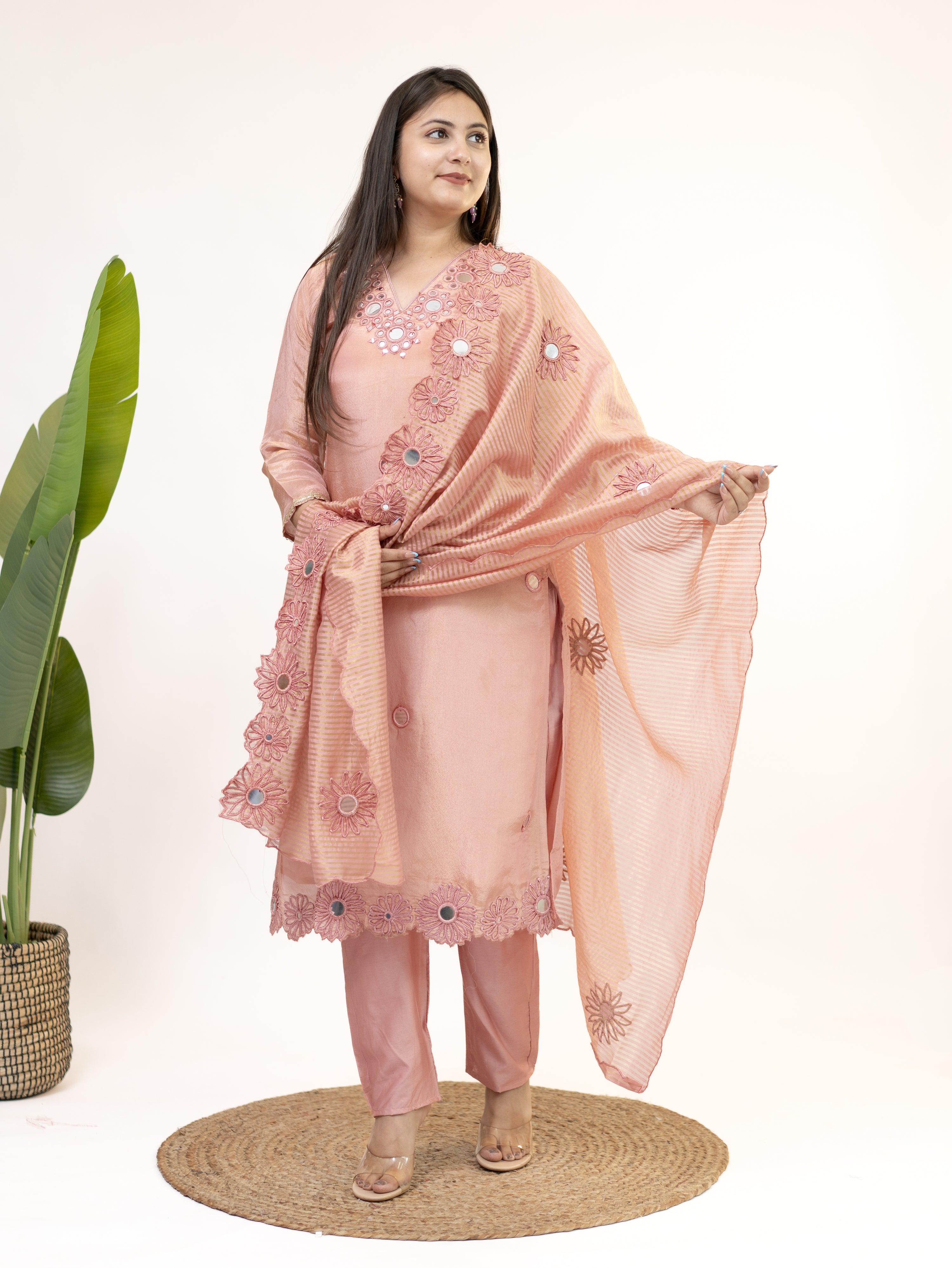Woman wearing a peach embroidered traditional outfit