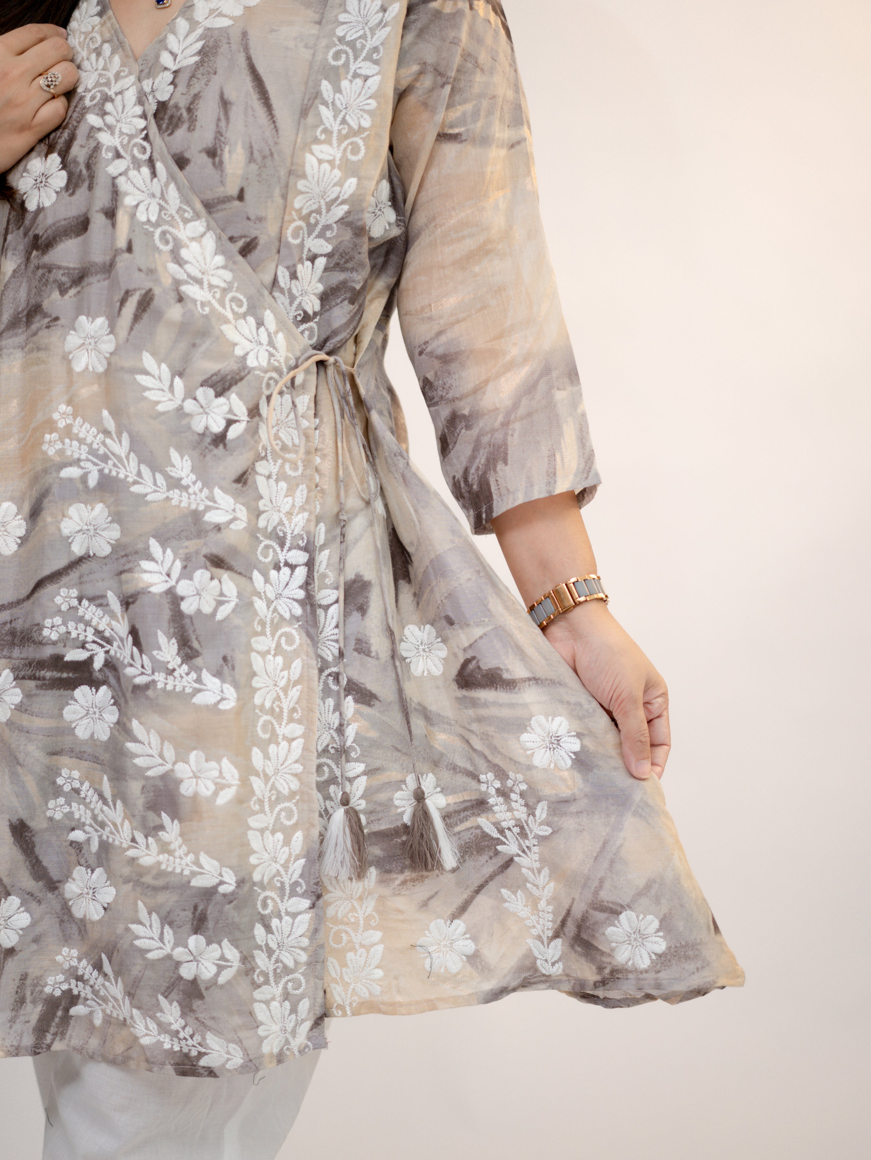 Fara mul cotton chikankari work A-line coord set close-up with floral embroidery, tassel tie-up, and soft neutral print